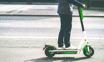 Driving electric scooter along asphalted road © Ievgen Skrypko