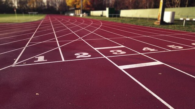 Aerial footage of running track in a sport stadium. first person view of a runner in a competition. Victory at the finishing line.