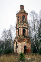 Fototapeta na wymiar Abandoned three-tiered Orthodox bell tower, Church of the Holy Trinity in Troitsa-Zazharye, Russia, Kostroma region
