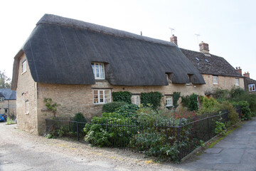 Fototapeta na wymiar A thatched cottage in Bampton, Oxfordshire in the United Kingdom
