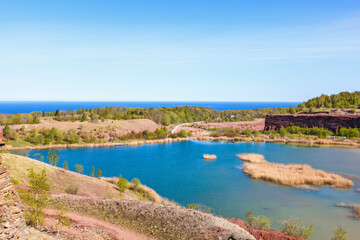Old abandoned open pit with a lake and rock walls