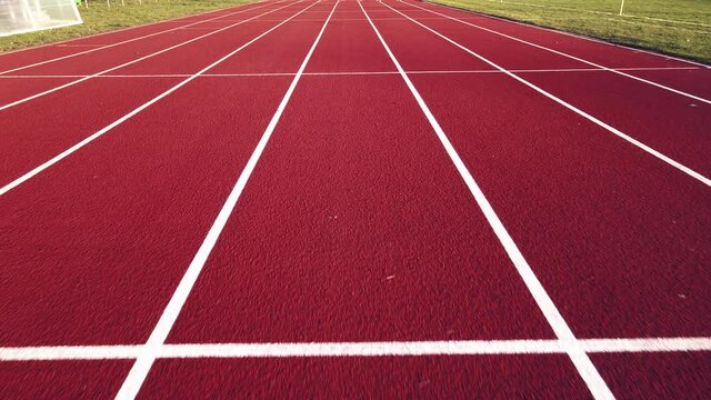 Aerial footage of running track in a sport stadium. first person view of a runner in a competition. Victory at the finishing line.