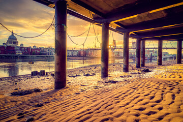 Millennium Bridge and St. Paul's cathedral at sunrise in London