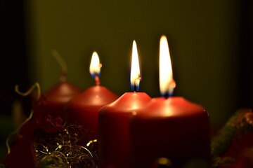 close up of an Advent arrangement with three burning candles