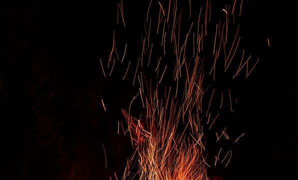 Bright sparks of fire on black background