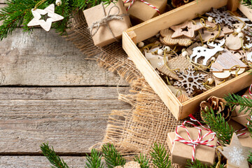 Wooden Christmas decorations in a wooden box. Ecological Christmas decorations in a box under the fir branches