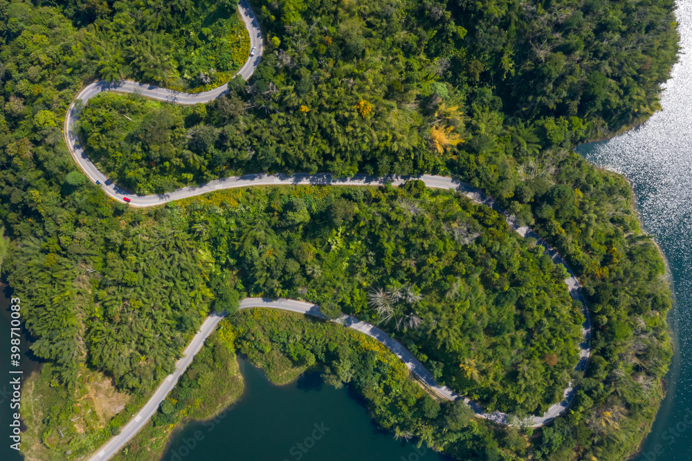 Wall mural aerial view road along mea suai dam connecting the city