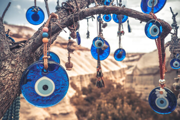 Amulets against evil eye hanging on tree branch in Turkey
