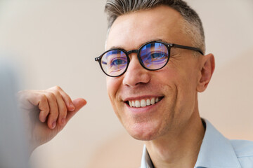 Close up of a smiling businessman sitting