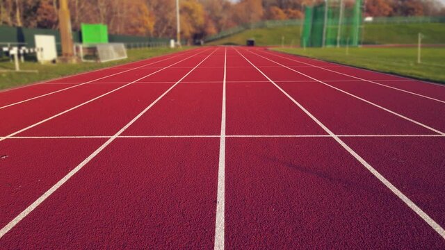 Aerial footage of running track in a sport stadium. first person view of a runner in a competition. Victory at the finishing line.