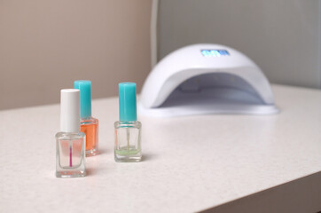 UV diode lamp lights for nails and set of cosmetic nail polish for manicure and pedicure on white...