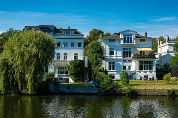 Fototapeta na wymiar Luxury villas and real estate on the Alster in the Winterhude district of Hamburg, Germany