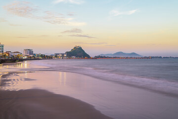 Obraz premium Beautiful city landscape from the viewpoint at Prachuap Khiri Khan Province, Thailand. Wat Khao Chong Krachok on top of mountain in sunset.