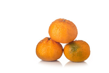 Tangerine with slices on a white background with reflection