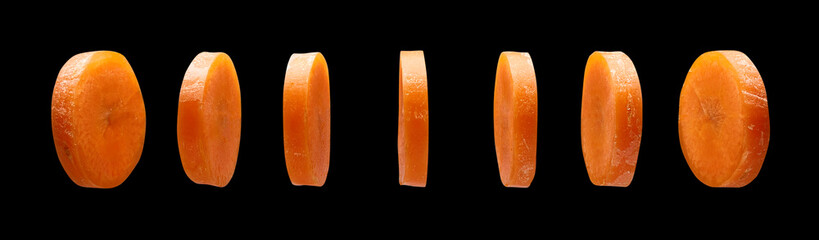 Carrot slices on black background, levitating