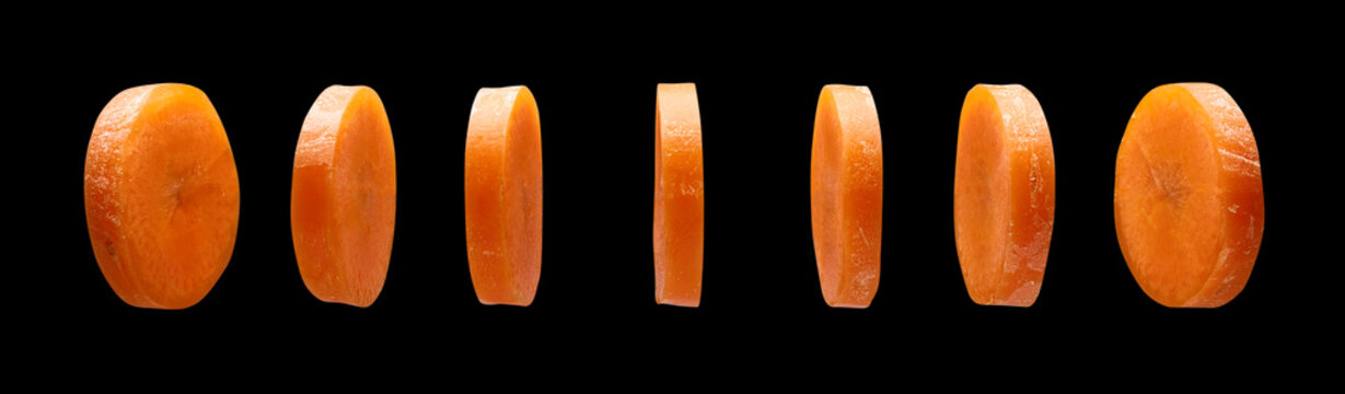 Carrot slices on black background, levitating