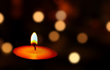 Burning candle with bokeh background
