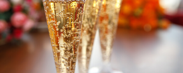 Glasses of sparkling wine in the light close-up. Lots of gas bubbles