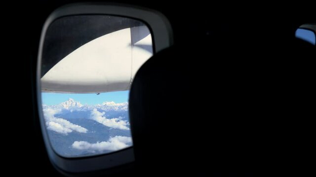 Gaurishankar 7146m south face with Melungtse massif being seemable in aircraft window during the Ramechhap to Lukla near the majestic Himalayan mountains flight.Light aviation and traveling concept.