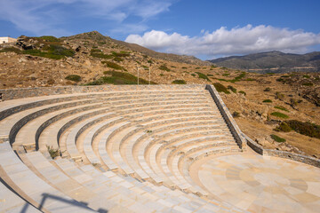 Fototapeta na wymiar The open-air theatre Odysseas Elytis made of stone and marble in the ancient Greek style on Ios Island. Cyclades Islands, Greece