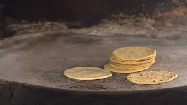 Smoking comal with tortillas. Corn tortillas in comal