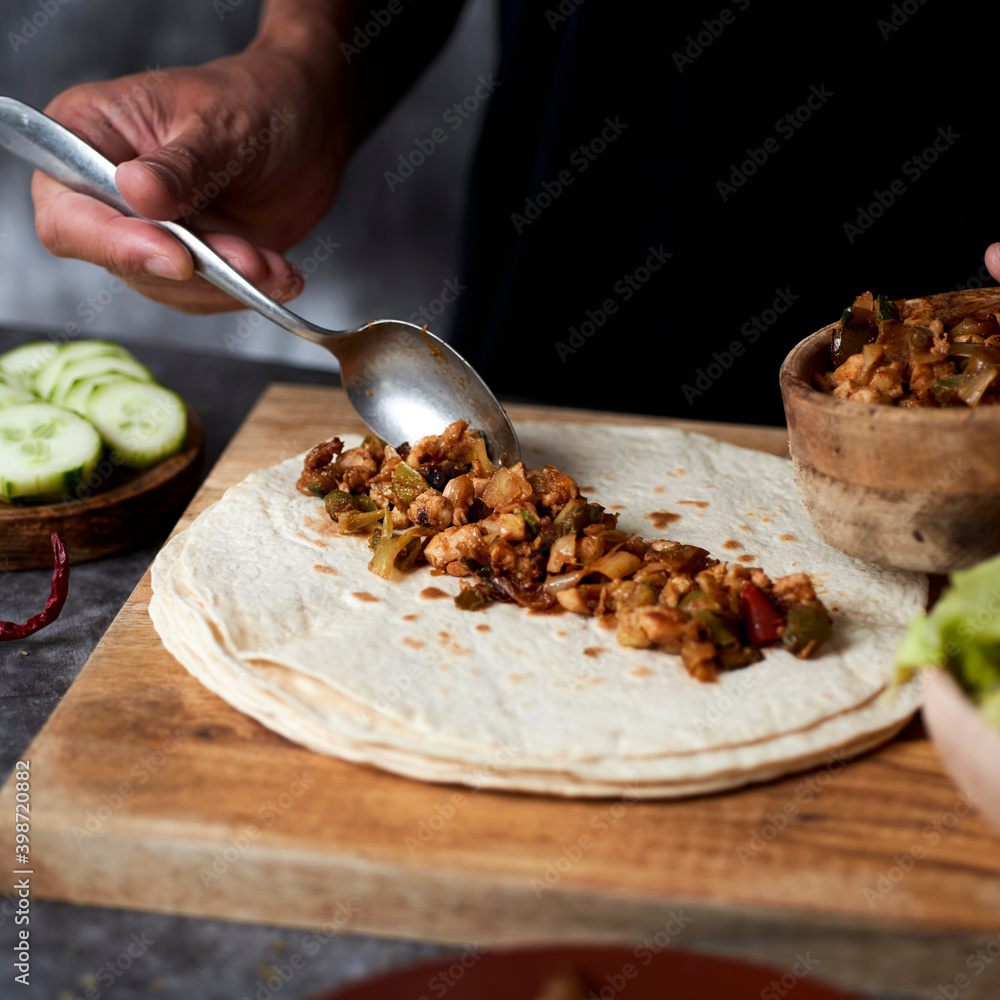 Poster man preparing a durum or a burrito