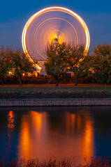 Mannheim, Germany. October 22th, 2009. Illuminated rotating ferris wheel on the Neckar River in the...