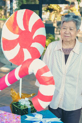 Fototapeta na wymiar asian old elder woman elderly senior with decorative gift present box at christmas
