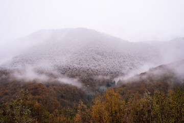 Landscape of mountains with cloudy sky and fog on a cloudy day. Autumn rainy day