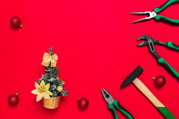 A set of quality green building tools to repair a car or house and Christmas tree on a red background. Do it yourself instruments. Banner for a New year advertise construction shop with copy space