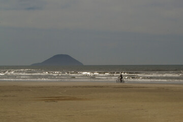 An empty beach on a sunny day with clouds in the sky