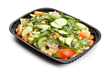 Take away chicken salad in a black plastic box. Studio photo isolated on white background.