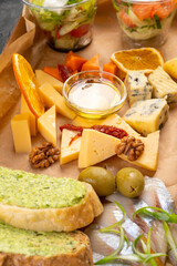 sliced cheese with honey, olives, baguette toast. Catering box. Delivery of snacks.