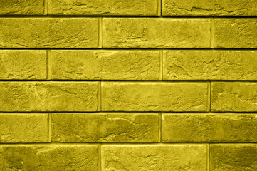 pattern of decorative yellow gray slate stone wall surface as a background. toned in illuminating and ultimate gray, trend color of the year 2021