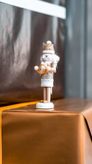 Nutcracker on top of stack of presents