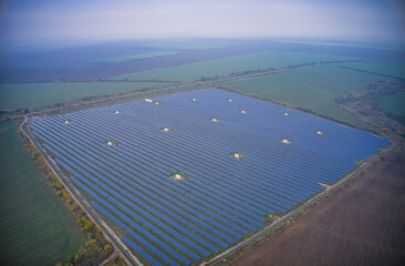 Fly over a renewable solar power plant with sun in Ukraine
