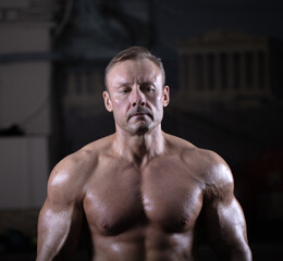 Fototapeta na wymiar Portrait of a male bodybuilder in the gym