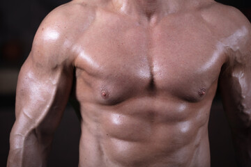 Athletic figure of a male bodybuilder. Torso of a male athlete
