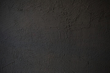 Textured background dark embossed plaster.