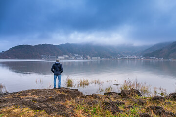 Fototapeta na wymiar Man looking at lake Kawaguchi in Japan 