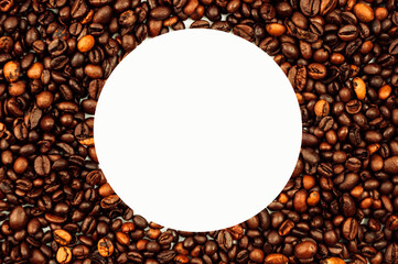 Coffee beans are scattered over the surface on a blank white background. a handful of brown coffee beans. Coffee background with copy space for an inscription, text or round logo. Mock up.
