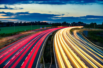 Colorful sunset at M1 motorway near Flitwick junction with cars light trails. United Kingdom