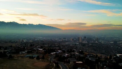 Aerial hyperlapse of Salt Lake City Utah during sunrise and a thermal inversion with air pollution visible