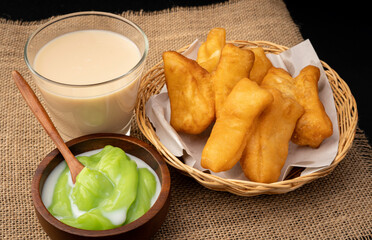 patongo or deep-fried dough and steamed custard with soy milk On a black background