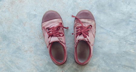 Old brown Sneaker on floor. Sneaker student on floor cement.