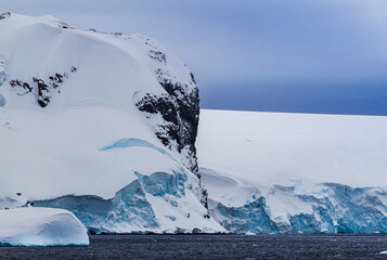 Close up of deep snow on mountain hill near the water in Antarctica