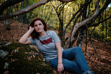 traveler hipster woman standing alone in autumn woods .