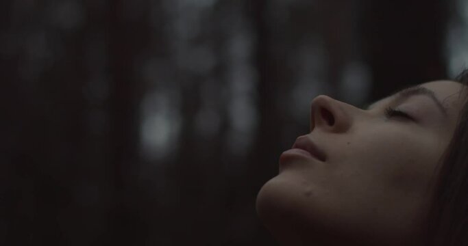Portrait Of Young Beautiful Girl Looks Up At Sky And Enjoys Nature Close-up. Attractive Brunette Woman Dreams Or Thinks About Something Outdoors. God Believer Prayer Passionate Dreamer Calm Atmosphere