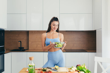 Beautiful fitness woman, prepares healthy food at home, loses weight, and teaches others healthy eating