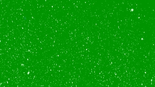 Fast falling white snow on a green background. Dynamic wind particles in the air. Animation video for design, chroma key. 4K.